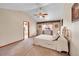 Comfortable main bedroom with vaulted ceiling, carpet, and ample natural light at 8167 S Dover St, Littleton, CO 80128
