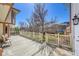 Large patio area overlooking the backyard, featuring white railing at 8167 S Dover St, Littleton, CO 80128