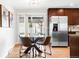 Eat-in kitchen with a glass table, four chairs, and stainless steel refrigerator at 2756 E Euclid Ave, Centennial, CO 80121