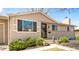 Ranch style home with a beautiful front yard, manicured shrubbery and steps to a black front door at 2756 E Euclid Ave, Centennial, CO 80121