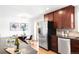Eat in kitchen with stainless steel appliances, dark cabinetry, and view to outdoor patio at 2756 E Euclid Ave, Centennial, CO 80121