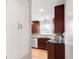Galley kitchen featuring stainless steel appliances and backsplash with wood floors at 2756 E Euclid Ave, Centennial, CO 80121