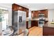 Kitchen with stainless steel appliances, dark cabinetry, and a dining table adjacent at 2756 E Euclid Ave, Centennial, CO 80121