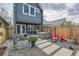 Backyard oasis featuring a hot tub, patio with dining area, and gravel landscape with stylish accents at 35 Elati St, Denver, CO 80223