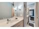 Bathroom vanity with white countertop and chrome faucet, featuring modern lighting and decor at 35 Elati St, Denver, CO 80223
