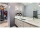 Modern bathroom featuring double sinks, a large mirror, and stylish storage at 35 Elati St, Denver, CO 80223