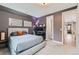 Inviting bedroom with neutral tones, soft carpet, and a modern platform bed, workspace, and hallway view at 35 Elati St, Denver, CO 80223
