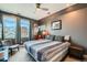 Comfortable bedroom with large windows, stylish decor, and soft natural light at 35 Elati St, Denver, CO 80223