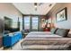 Bedroom featuring a large bed, mounted TV, and light-filled windows at 35 Elati St, Denver, CO 80223