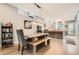 Bright dining area flowing into a modern kitchen, featuring a wooden table, bench, and stylish lighting at 35 Elati St, Denver, CO 80223