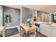 Modern kitchen with stainless steel appliances, island, and open staircase at 35 Elati St, Denver, CO 80223