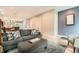 Open-concept living area with stylish decor, wood floors, and a seamless transition to the kitchen and dining spaces at 35 Elati St, Denver, CO 80223