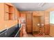 A galley kitchen with wood cabinets and laminate countertops at 5493 Quari St, Denver, CO 80239