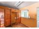 View of kitchen with wood cabinets and orange walls at 5493 Quari St, Denver, CO 80239