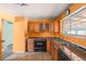 Kitchen with wood cabinets, stove, and double sink at 5493 Quari St, Denver, CO 80239