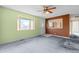 Living room with light green walls, carpet, and ceiling fan at 5493 Quari St, Denver, CO 80239