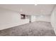 Finished basement space featuring new carpet, recessed lighting, and a white accent wall at 1824 S Columbine St, Denver, CO 80210