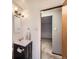 Updated bathroom with modern fixtures, vanity lighting, and a sleek mirror at 1824 S Columbine St, Denver, CO 80210