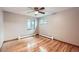 Spacious bedroom boasting hardwood floors, two windows, and neutral walls at 1824 S Columbine St, Denver, CO 80210