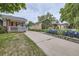 Charming home with a well-maintained lawn and colorful flower beds along the driveway at 1824 S Columbine St, Denver, CO 80210