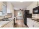 Bright kitchen features white cabinetry, granite countertops, and stainless steel appliances at 1824 S Columbine St, Denver, CO 80210