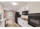 Modern kitchen with stainless steel appliances, granite countertops, and ample cabinet space at 1824 S Columbine St, Denver, CO 80210