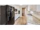 Updated kitchen with granite countertops, stainless steel appliances, and white cabinetry at 1824 S Columbine St, Denver, CO 80210