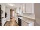 Well-lit kitchen with granite countertops, stainless steel appliances, and white cabinets at 1824 S Columbine St, Denver, CO 80210