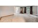 Spacious living room with plush carpeting, large windows, and neutral wall color at 1824 S Columbine St, Denver, CO 80210