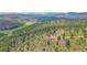 Sprawling home surrounded by mature trees and expansive acreage at 31231 Red Hawk Trl, Conifer, CO 80433