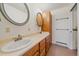 Bathroom features dual sinks, wood cabinets, oval mirrors, and plenty of towel racks at 31231 Red Hawk Trl, Conifer, CO 80433