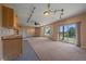 Spacious bonus room has carpet, a wet bar, and mountain views from sliding glass doors at 31231 Red Hawk Trl, Conifer, CO 80433