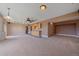 Spacious bonus room has carpet, a wet bar, a ceiling fan, and great views at 31231 Red Hawk Trl, Conifer, CO 80433