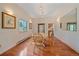 Cozy dining room with hardwood floors, a wooden table set for four, and a decorative display cabinet at 31231 Red Hawk Trl, Conifer, CO 80433
