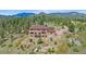 Stunning exterior elevation of a multi-story home with a beautiful mountain backdrop at 31231 Red Hawk Trl, Conifer, CO 80433
