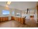 Large kitchen with wood cabinets, laminate flooring, and a spacious countertop with views of the mountains at 31231 Red Hawk Trl, Conifer, CO 80433