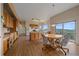 Open kitchen and dining area with wood cabinets, sliding glass doors, and beautiful mountain views at 31231 Red Hawk Trl, Conifer, CO 80433