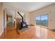 Living room with a wood-burning stove and sliding glass doors leading to a deck with mountain views at 31231 Red Hawk Trl, Conifer, CO 80433