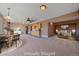 Open concept living space featuring dining area, wet bar and living room at 31231 Red Hawk Trl, Conifer, CO 80433