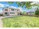 View of house from the large backyard with lush green grass at 5789 S Jay St, Littleton, CO 80123