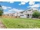Large backyard with green grass, a wooden fence and a basketball hoop at 5789 S Jay St, Littleton, CO 80123