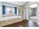 Bathroom featuring a large bathtub and glass shower at 5789 S Jay St, Littleton, CO 80123