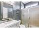Bathroom features a shower with a glass door, vanity, and mirror at 5789 S Jay St, Littleton, CO 80123