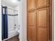Bathroom featuring a shower and wooden storage cabinets at 5789 S Jay St, Littleton, CO 80123