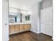 Bathroom features double sinks, wood cabinets, and a large mirror at 5789 S Jay St, Littleton, CO 80123