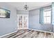 Cozy bedroom featuring gray walls, wood floors, natural light, and french doors at 5789 S Jay St, Littleton, CO 80123