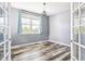 Bedroom with wood flooring, natural light, and french doors at 5789 S Jay St, Littleton, CO 80123