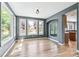 Sunlit dining room featuring gray walls, hardwood floors, and large windows with backyard views at 5789 S Jay St, Littleton, CO 80123