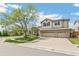 Two-story home with three-car garage and a mature shade tree at 5789 S Jay St, Littleton, CO 80123