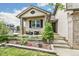 Inviting front porch with seating area, complemented by a well-maintained garden and attractive home facade at 5789 S Jay St, Littleton, CO 80123